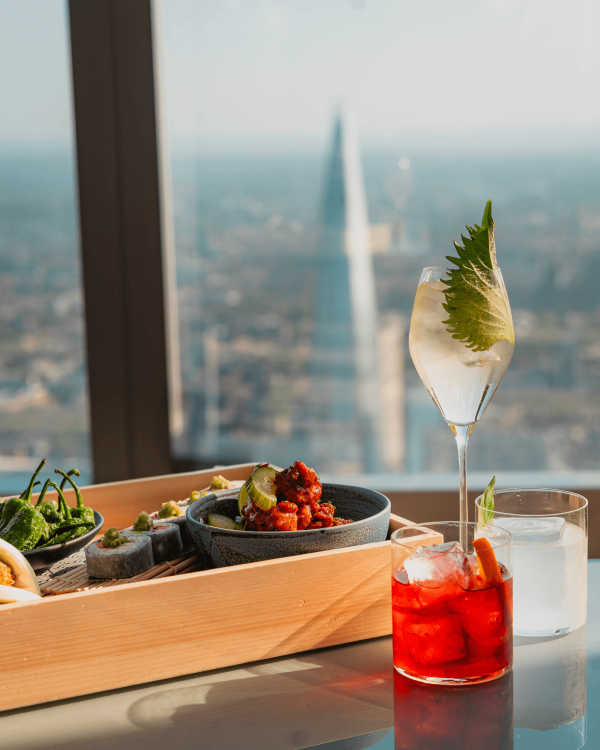 A plate of food served with various cocktails at Lucky Cat 22 Bishopsgate