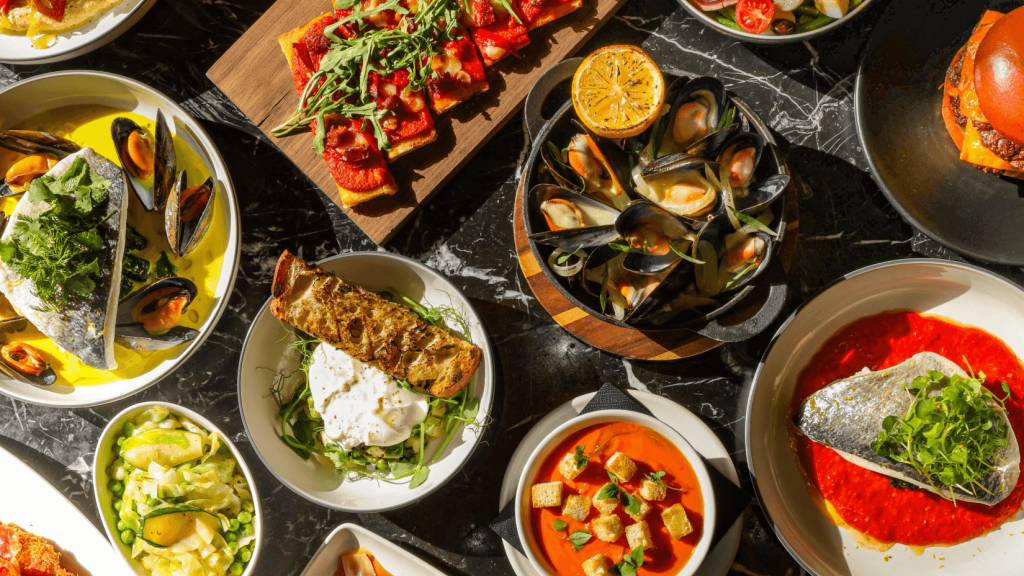 A table spread of the BSK spring menu items, seafood, salads, soups and burgers