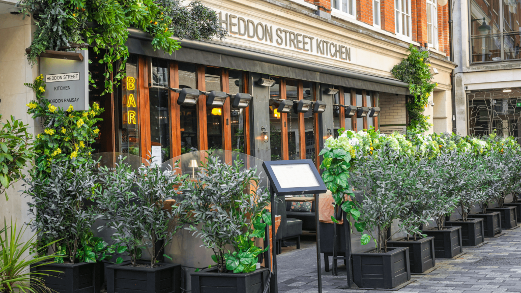 The front entrance and outdoor dining area of Heddon Street Kitchen Restaurant in Soho.