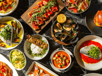 A table spread of the BSK spring menu items, seafood, salads, soups and burgers