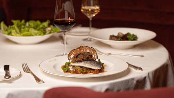 Sea bream dish with wine at Savoy Grill Restaurant pre-theatre dining London