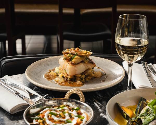 Elegant fine dining dish with white wine at Bread Street Kitchen restaurant